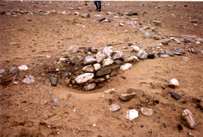 Severe weather erosion revealing distinct wall markings in the sand